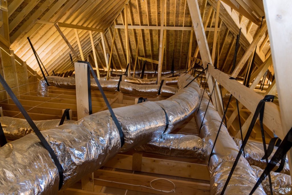 Ducts for central air conditioning being installed as part of new home construction