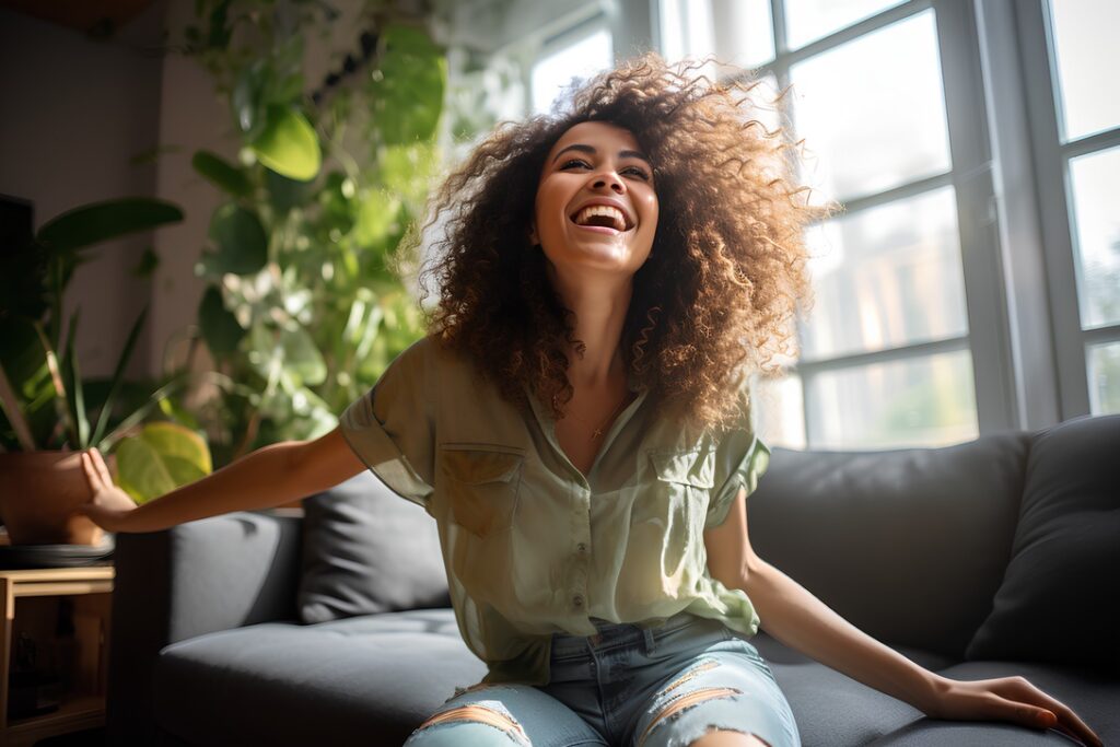 Smiling woman in house with whole-home humidifier installed in HVAC system